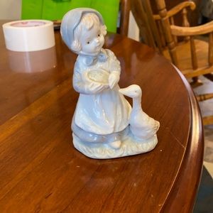 Little girl with duck figure